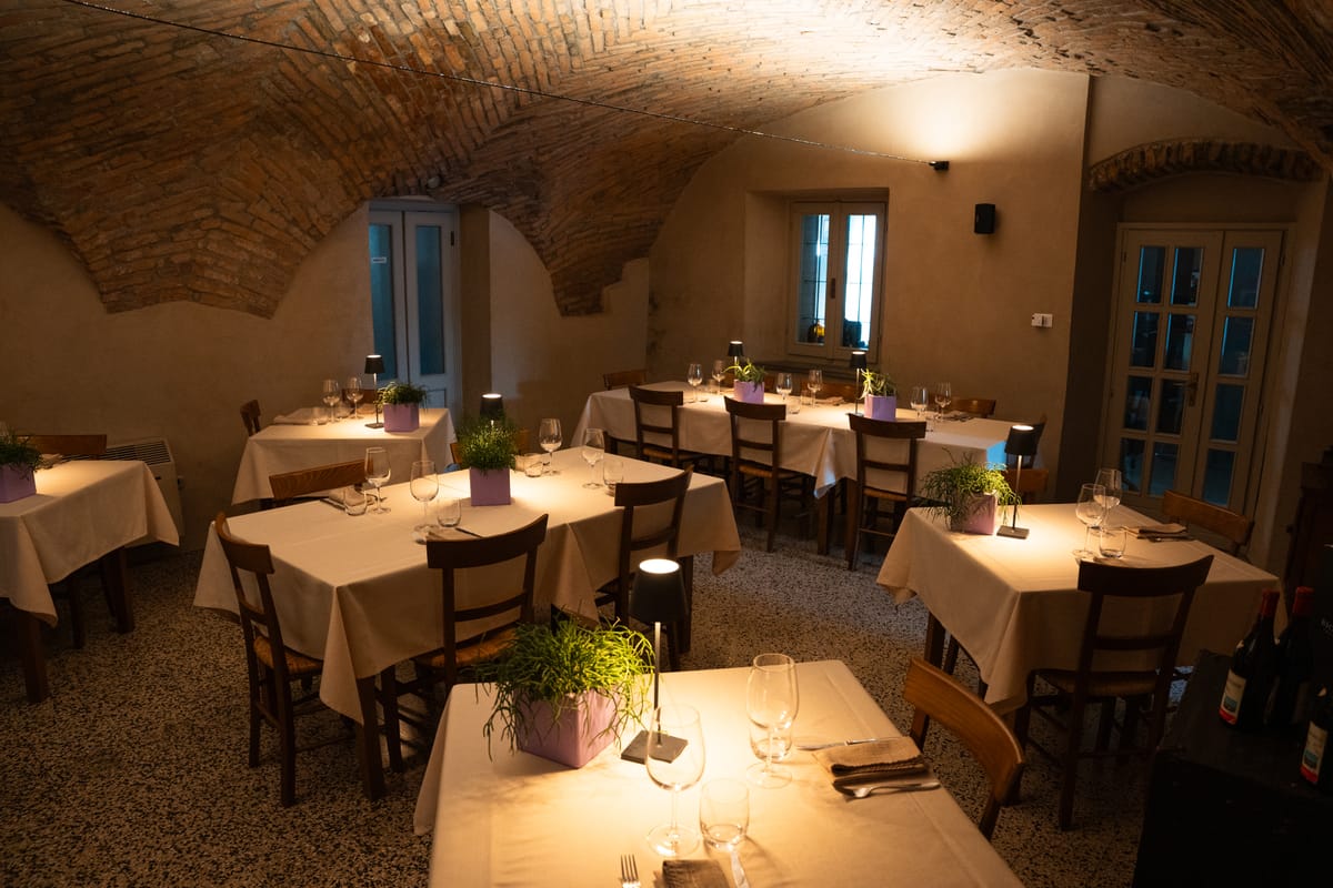 The brick-vaulted room laid for dinner