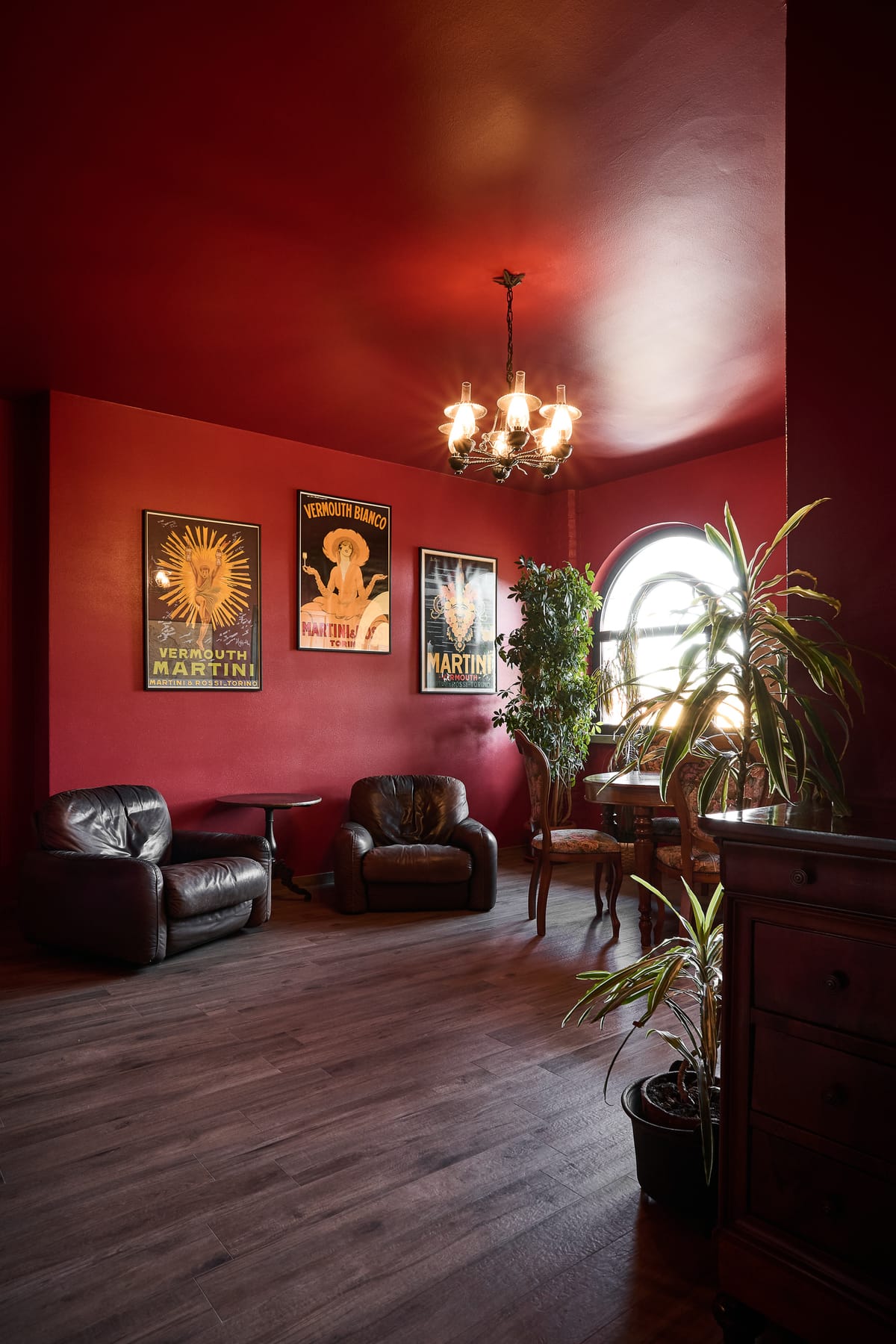 The red lounge with its chandelier and vintage posters