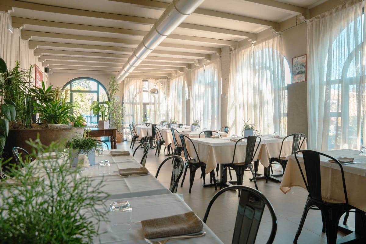 The restaurant veranda with arched windows and plants